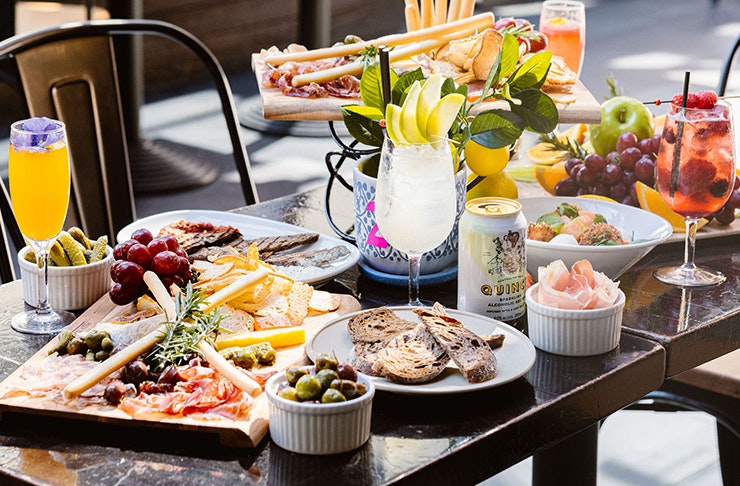 food spread on table with wine and drinks